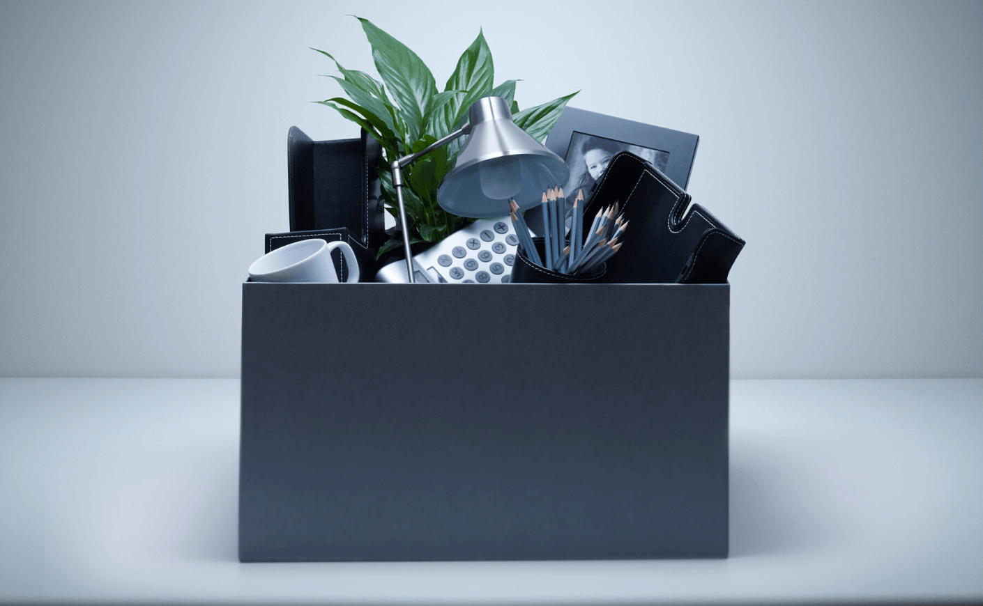 a cardboard box full of office supplies
