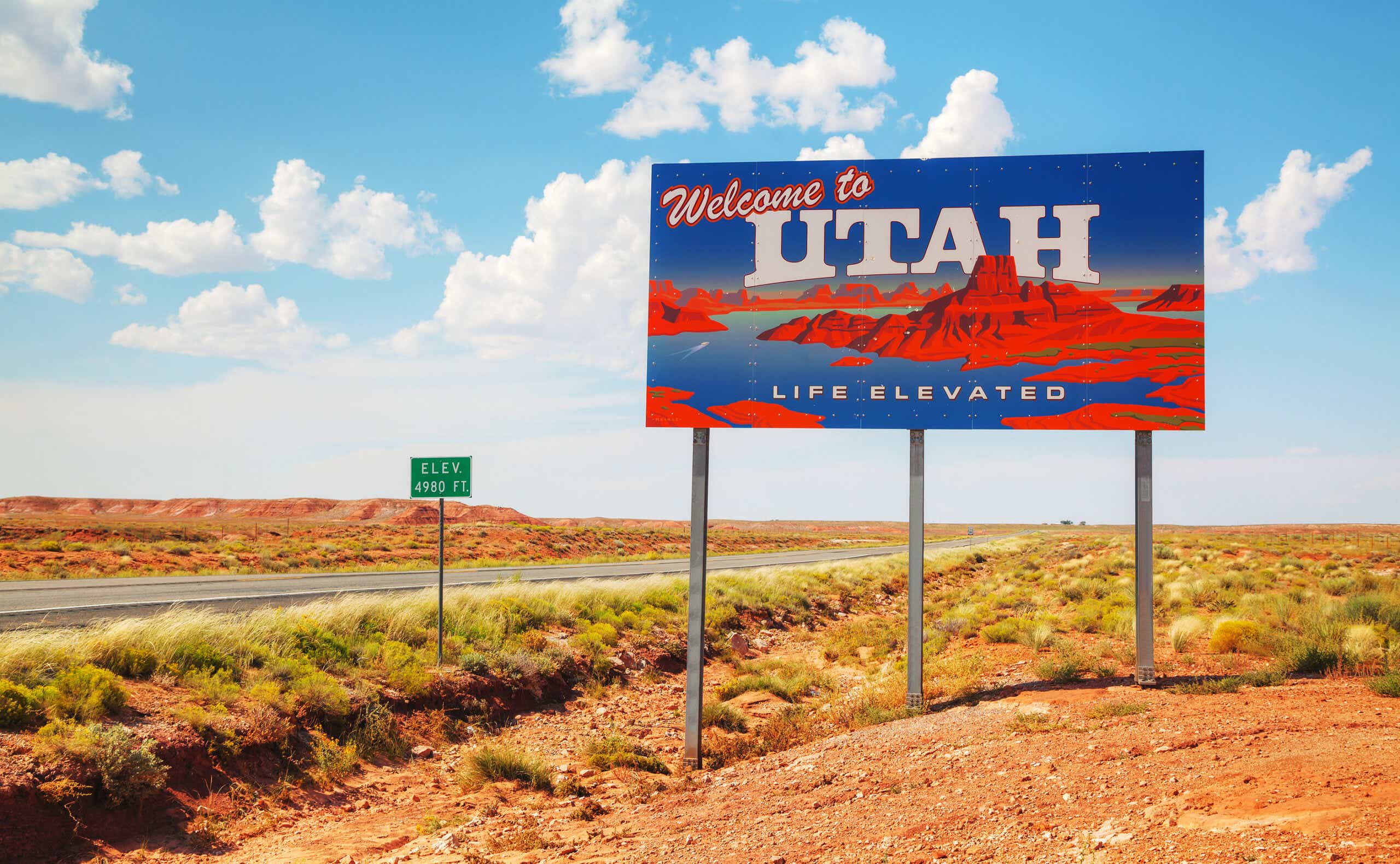 a welcome to utah sign on the highway