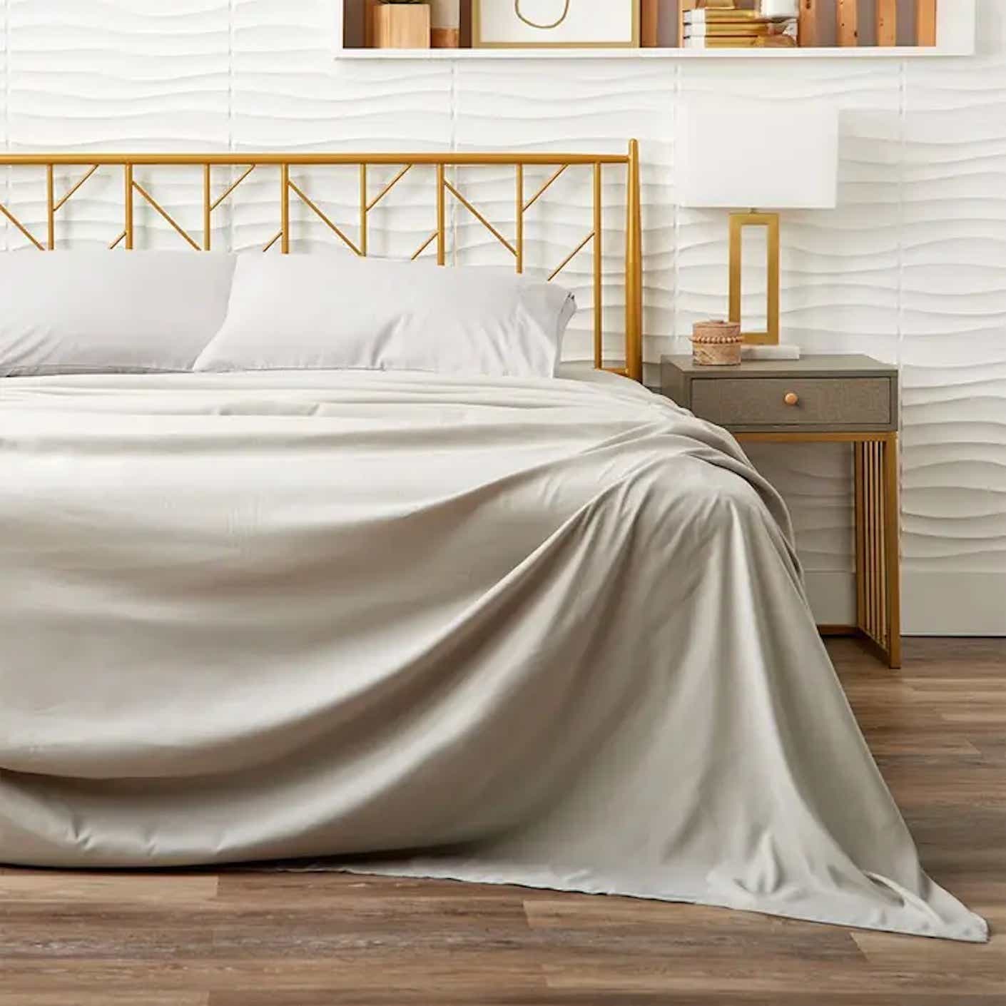 A bed is covered with white sheets.