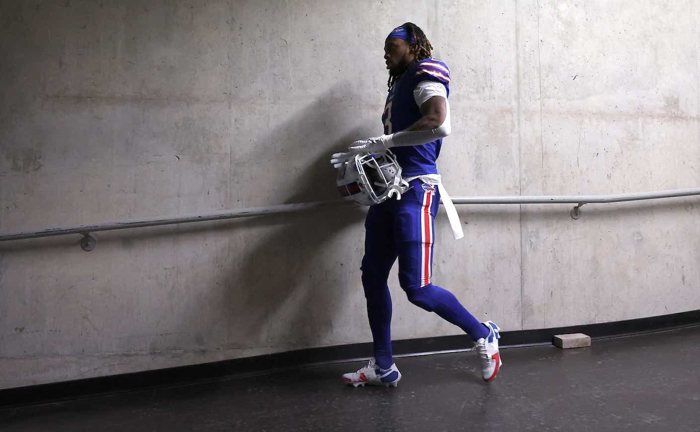 football player damar hamlin walks into locker room
