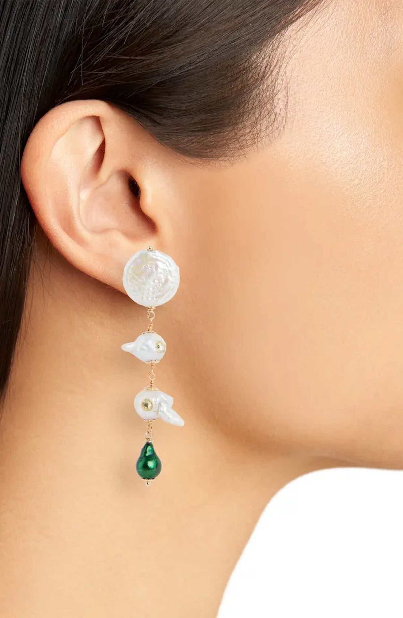 An earring hangs off an earlobe.