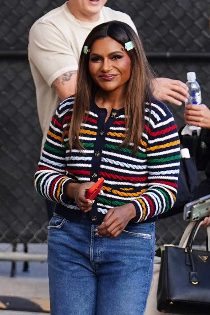 Mindy Kaling smiles in striped cardigan