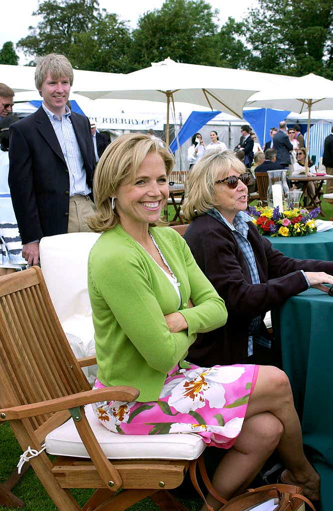 Katie Couric smiles in green cardigan over pink floral dress