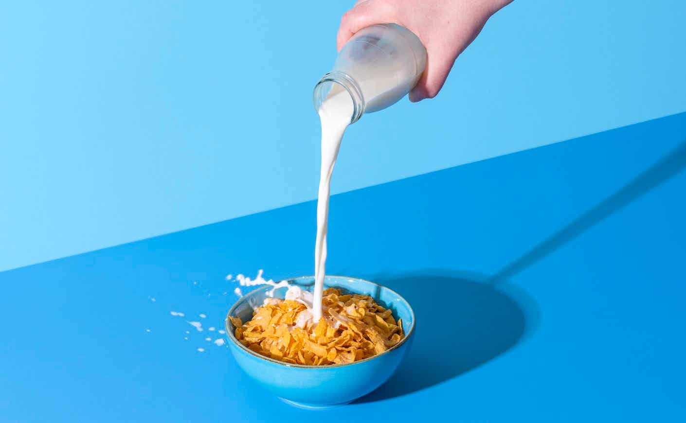 person pouring cereal