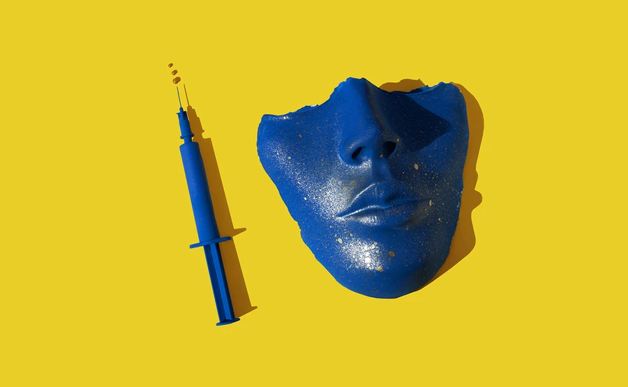 blue syringe next to blue mask broken off below the eyes, on a yellow background