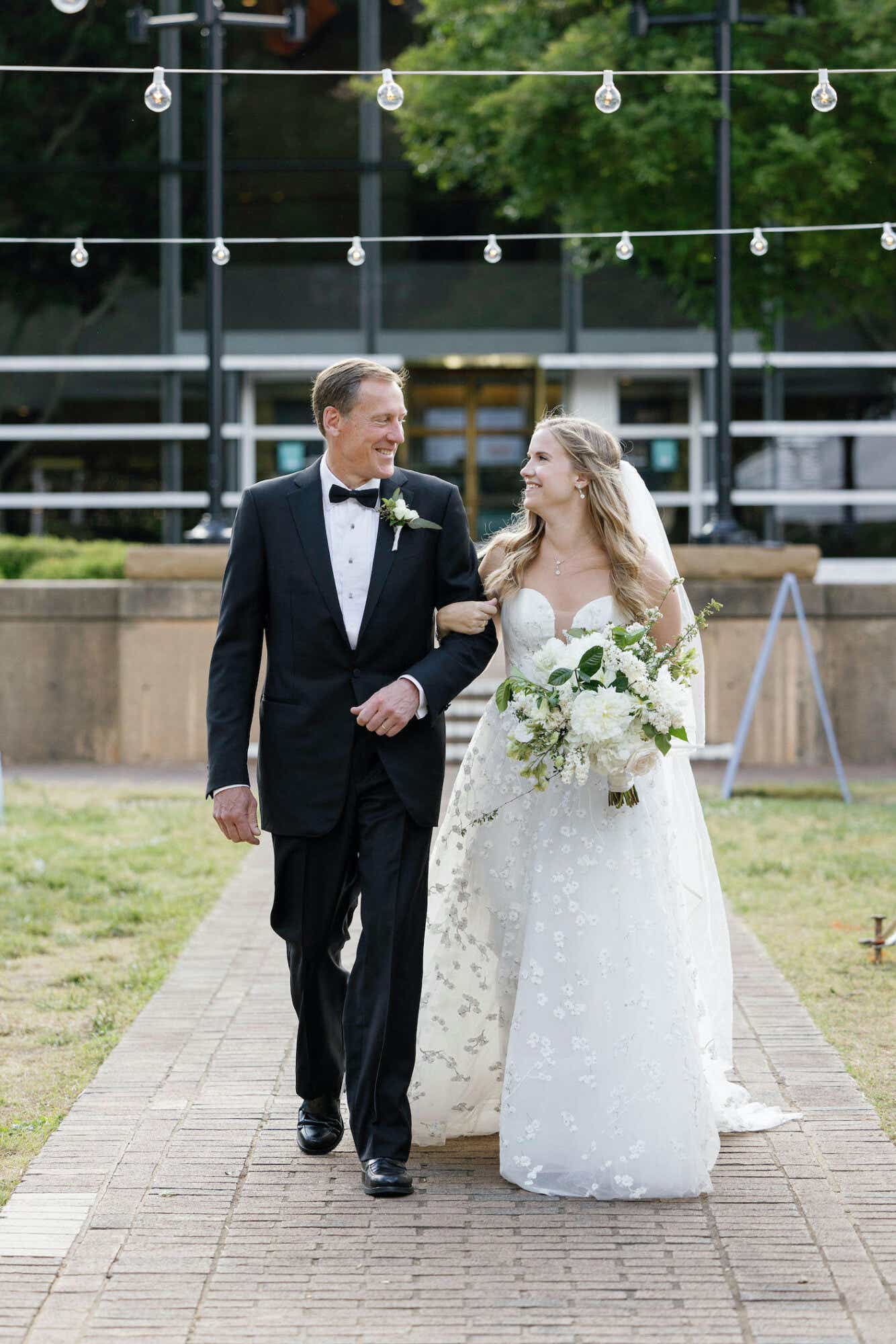 Kathy's husband walks their daughter down the aisle on her wedding day.