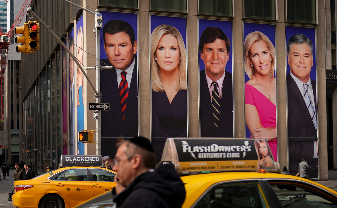 A billboard in New York City displays the faces of Fox News hosts