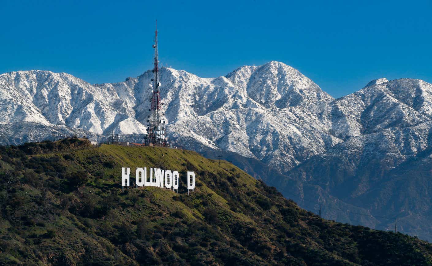 A view of the Hollywood Sign atop Mount Lee against the snow-covered San Gabriel Mountains on March 02, 2023
