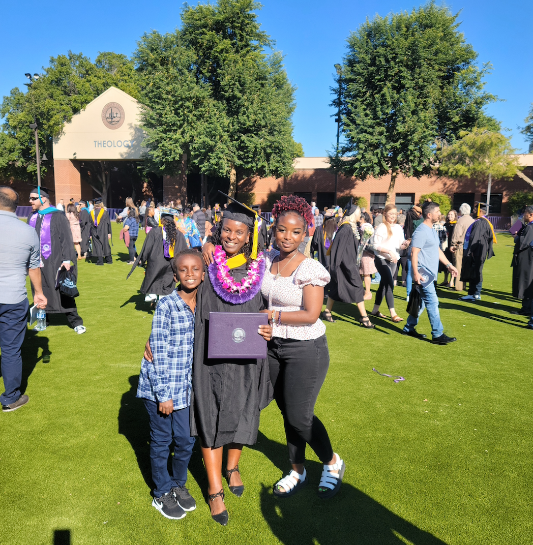 Jemimah smiles at her college graduation with her two children