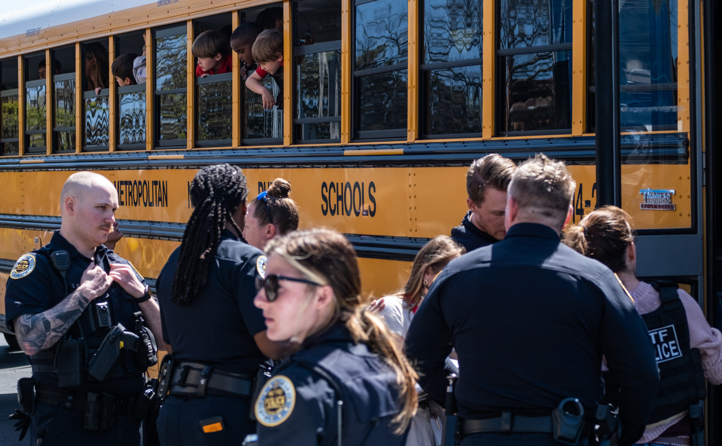 Police stand outside a school bus