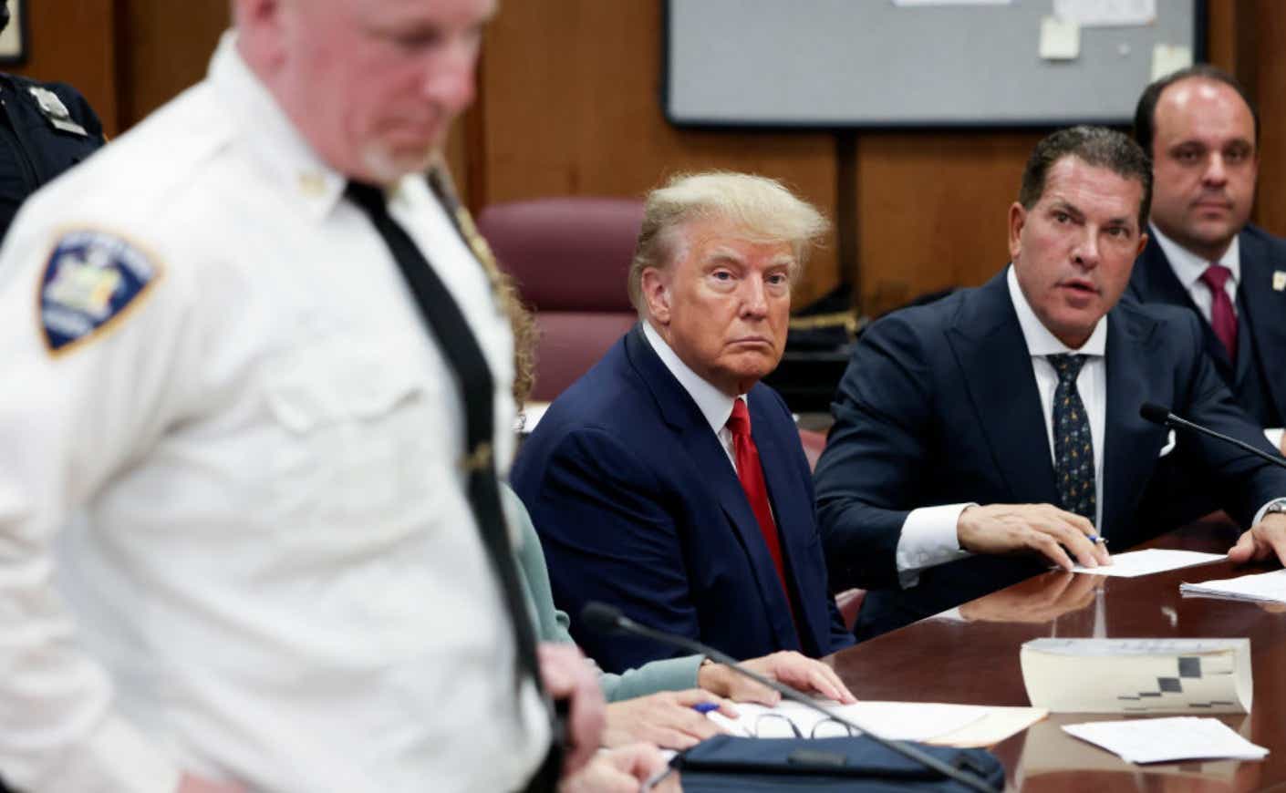 Trump sits in courtroom