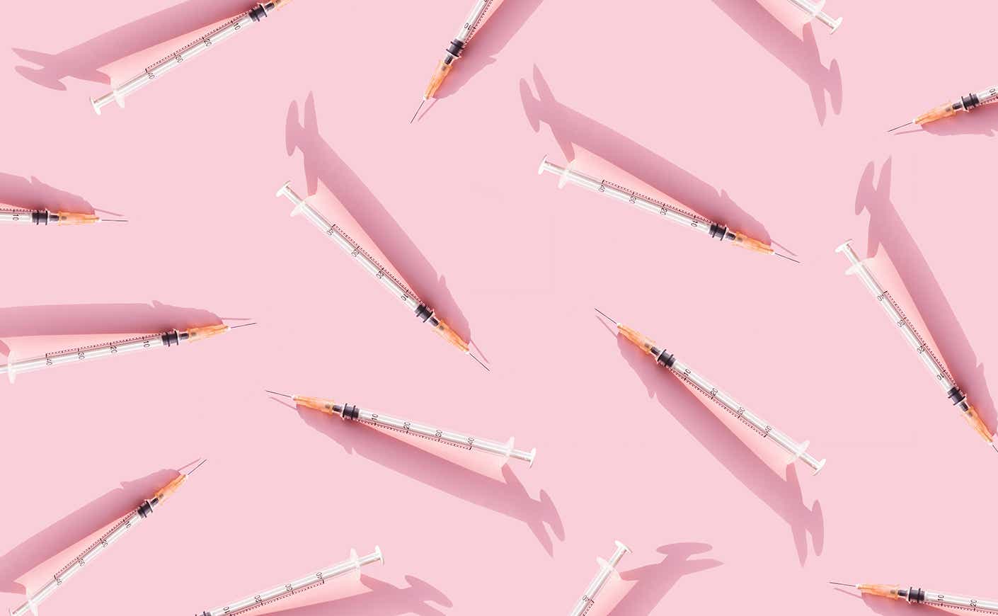syringes on a light pink background