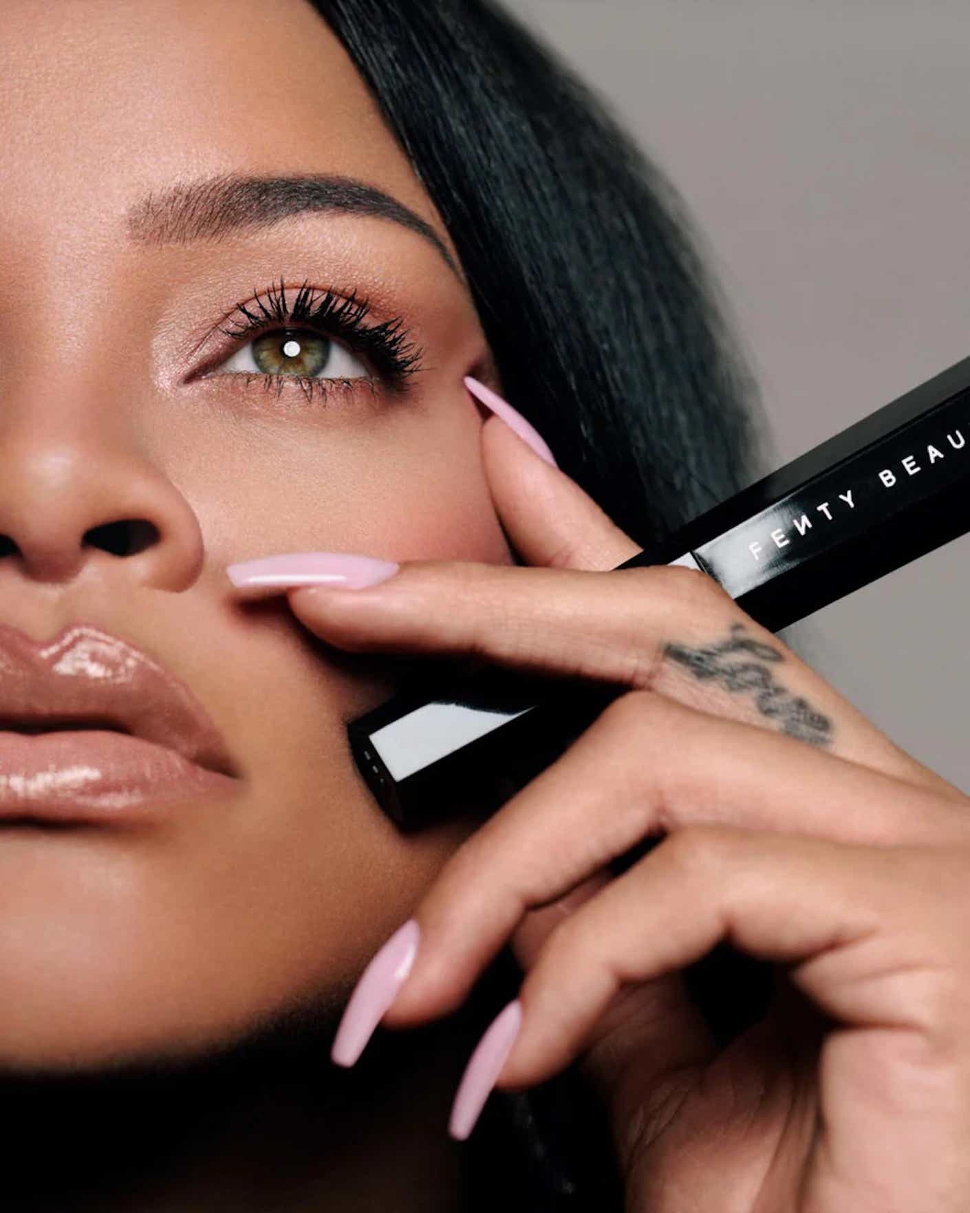 Rihanna poses with mascara