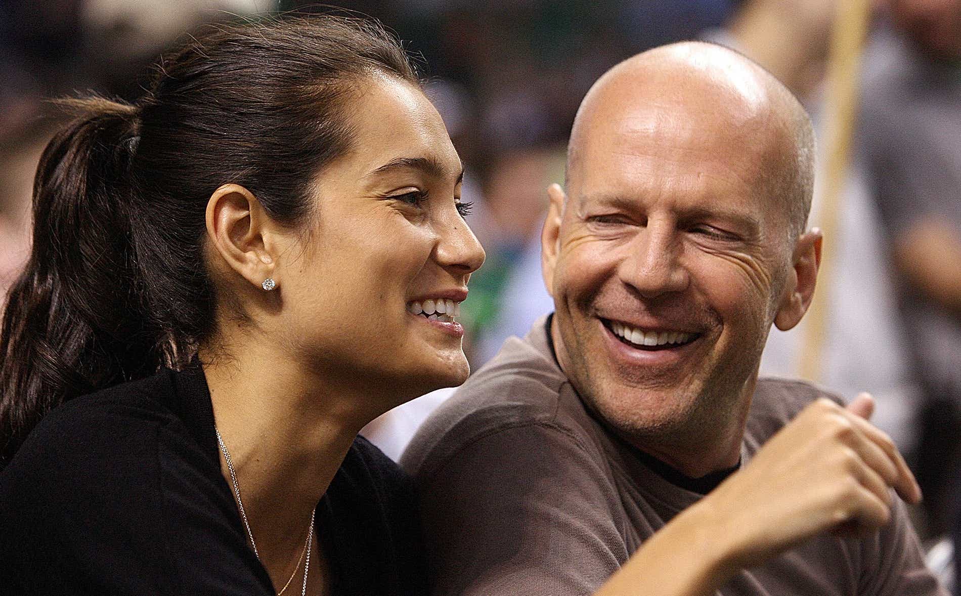 Bruce Willis and Emma Hemming on the sidelines during the first quarter of Game 2 of an NBA first-round playoff