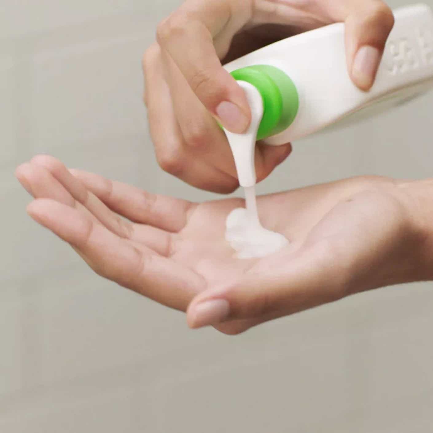 Someone puts cleanser onto their hand