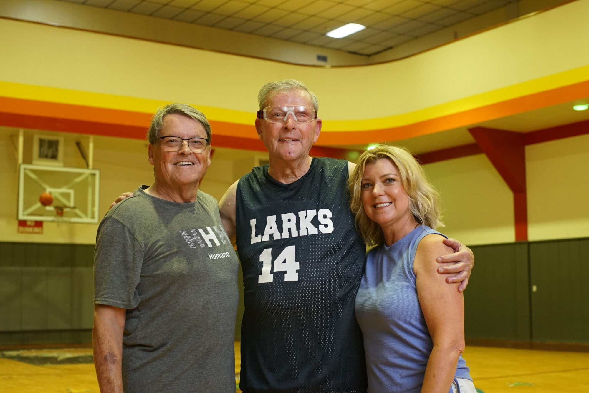 three family members on a basketball court