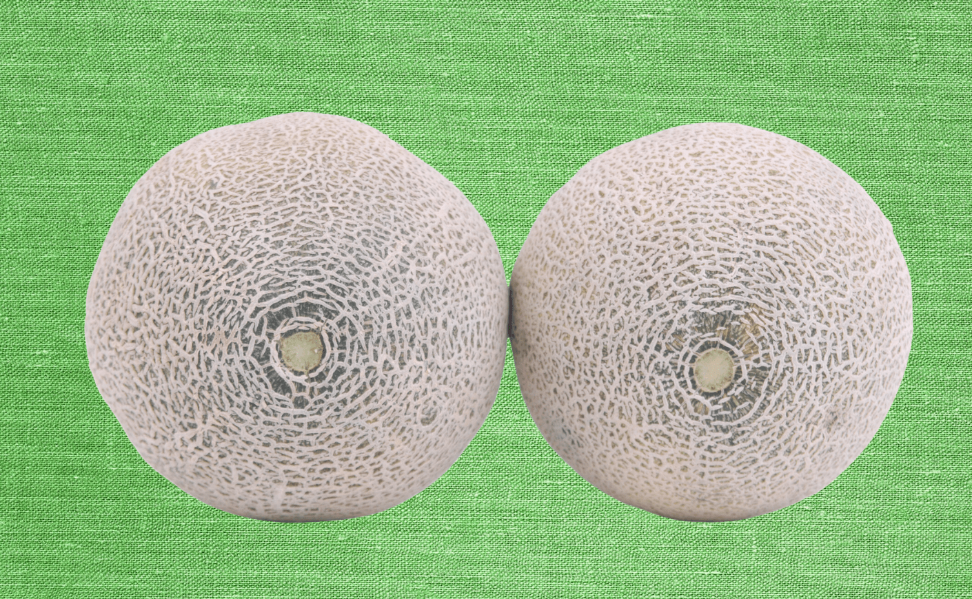 two cantaloupes on a green background