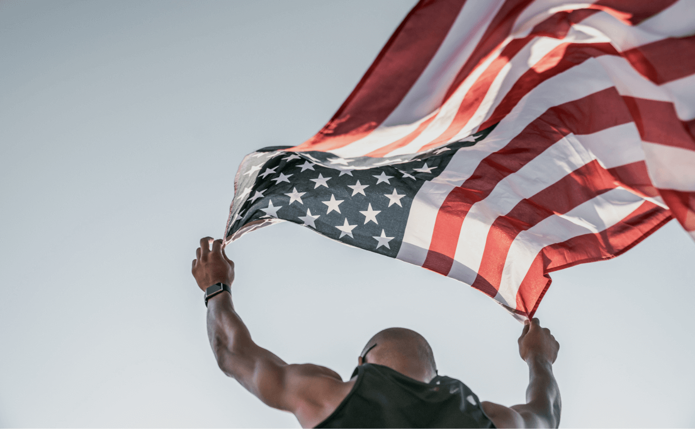 man running with an american flag