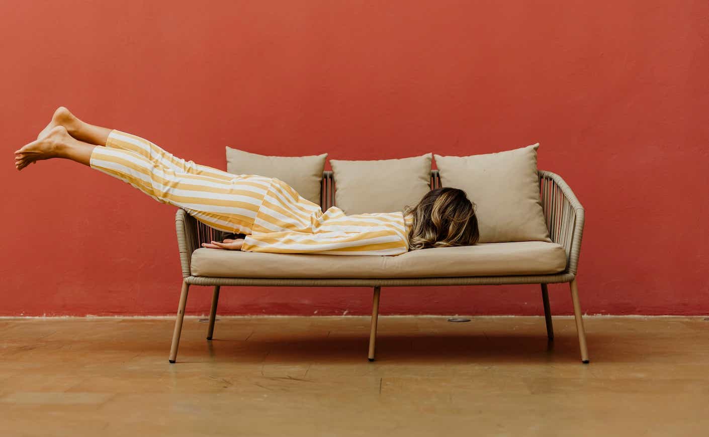 woman laying face down on couch