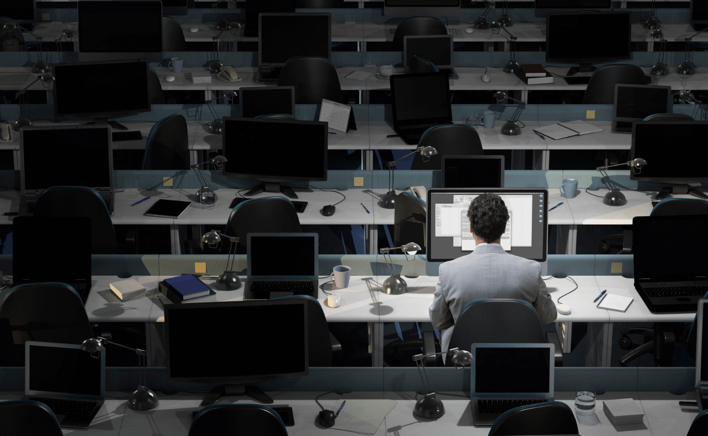 man at a computer working at night