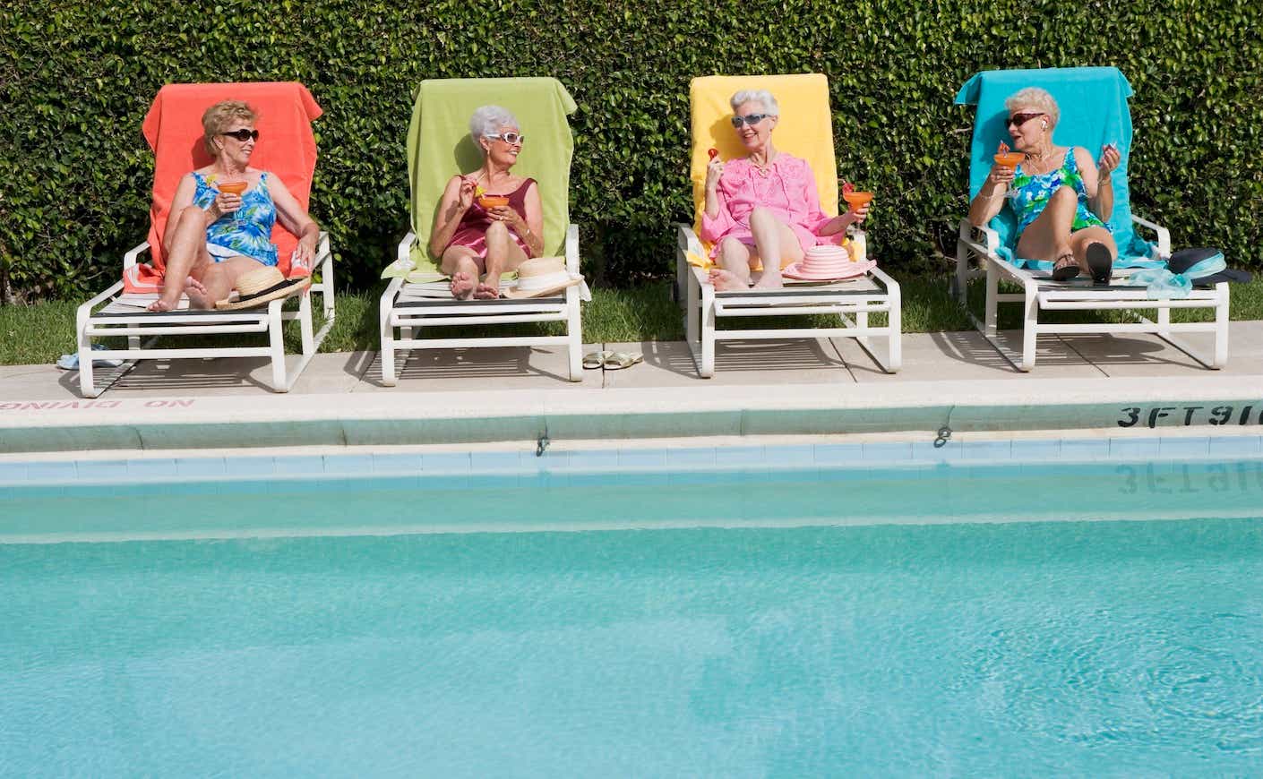 older ladies sitting by a pool