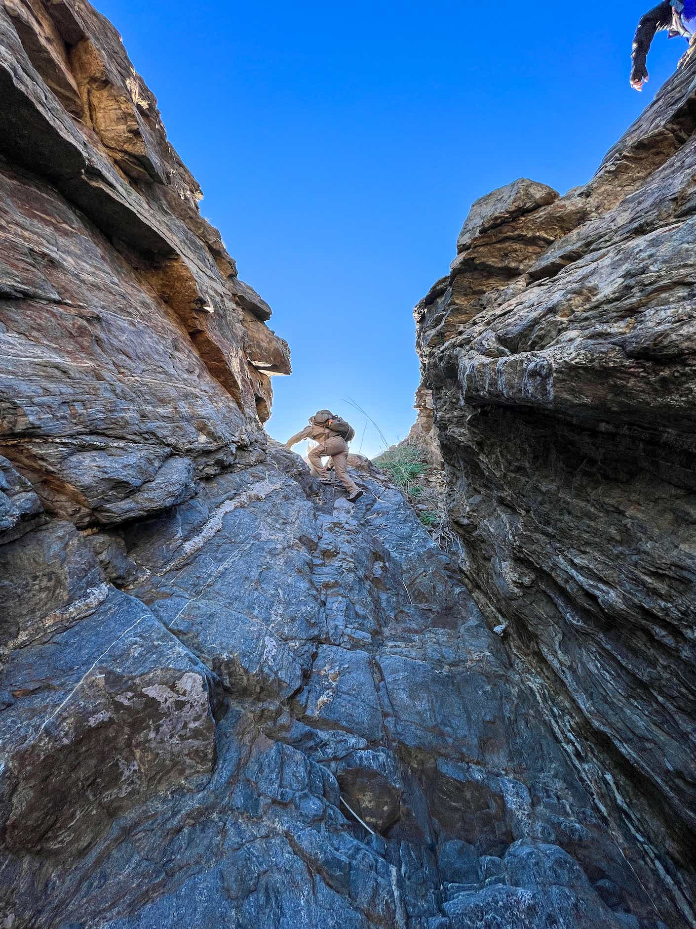 A person climbs a cliff