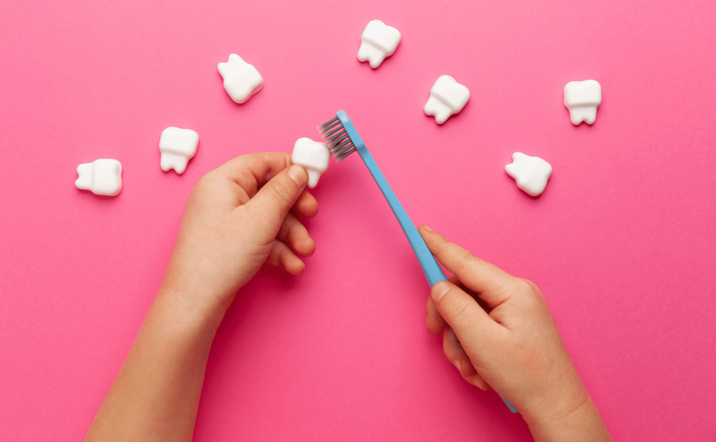 brushing teeth on pink background