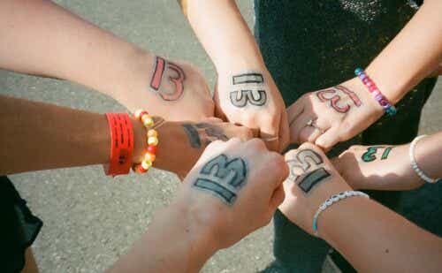 a circle of women's hands with 13 written on them
