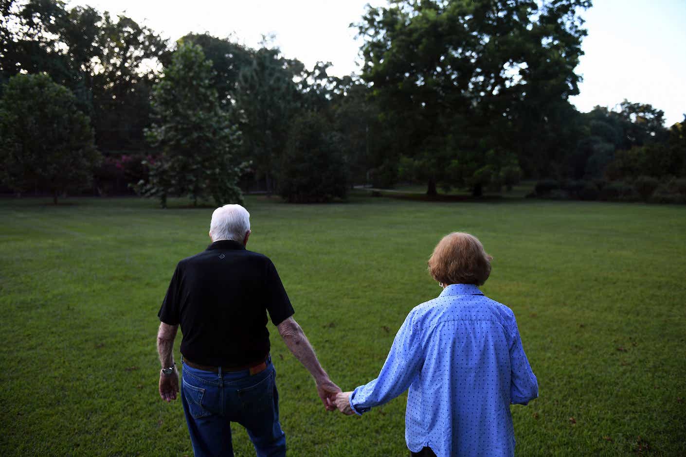 former President of the United States, Jimmy Carter walks with his wife, former First Lady, Rosalynn Carter towards their home following dinner at a friend's home on Saturday August 04, 2018 in Plains, GA