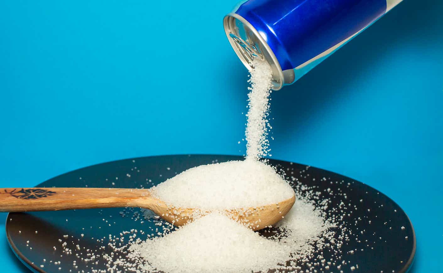 Sugar pours from energy drink can