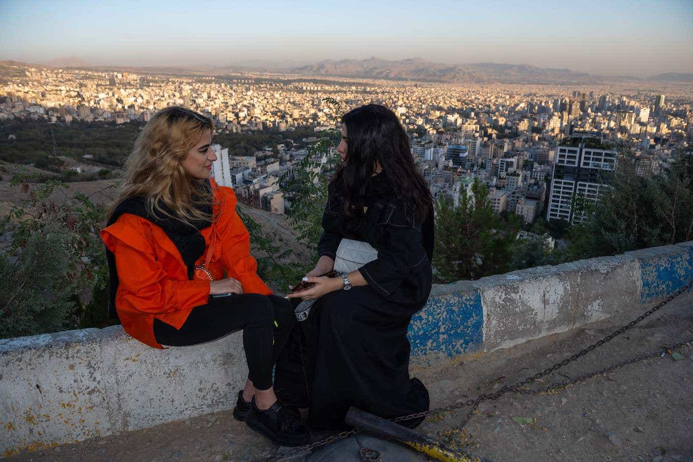 Two young Iranian girls, not wearing the mandatory hijab, visit 'Bame-Tehran.' 