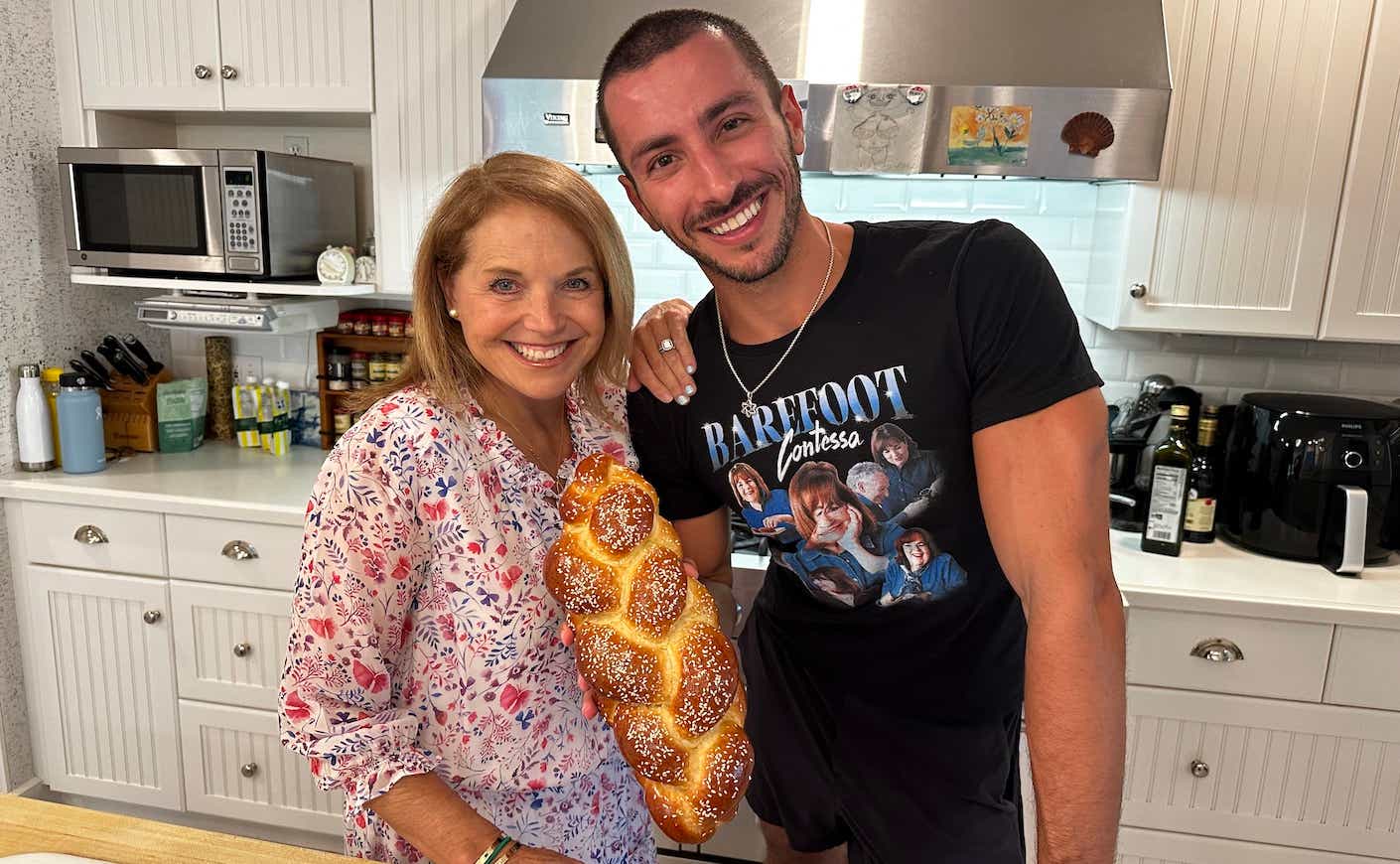 katie couric and jake cohen holding a loaf of challah