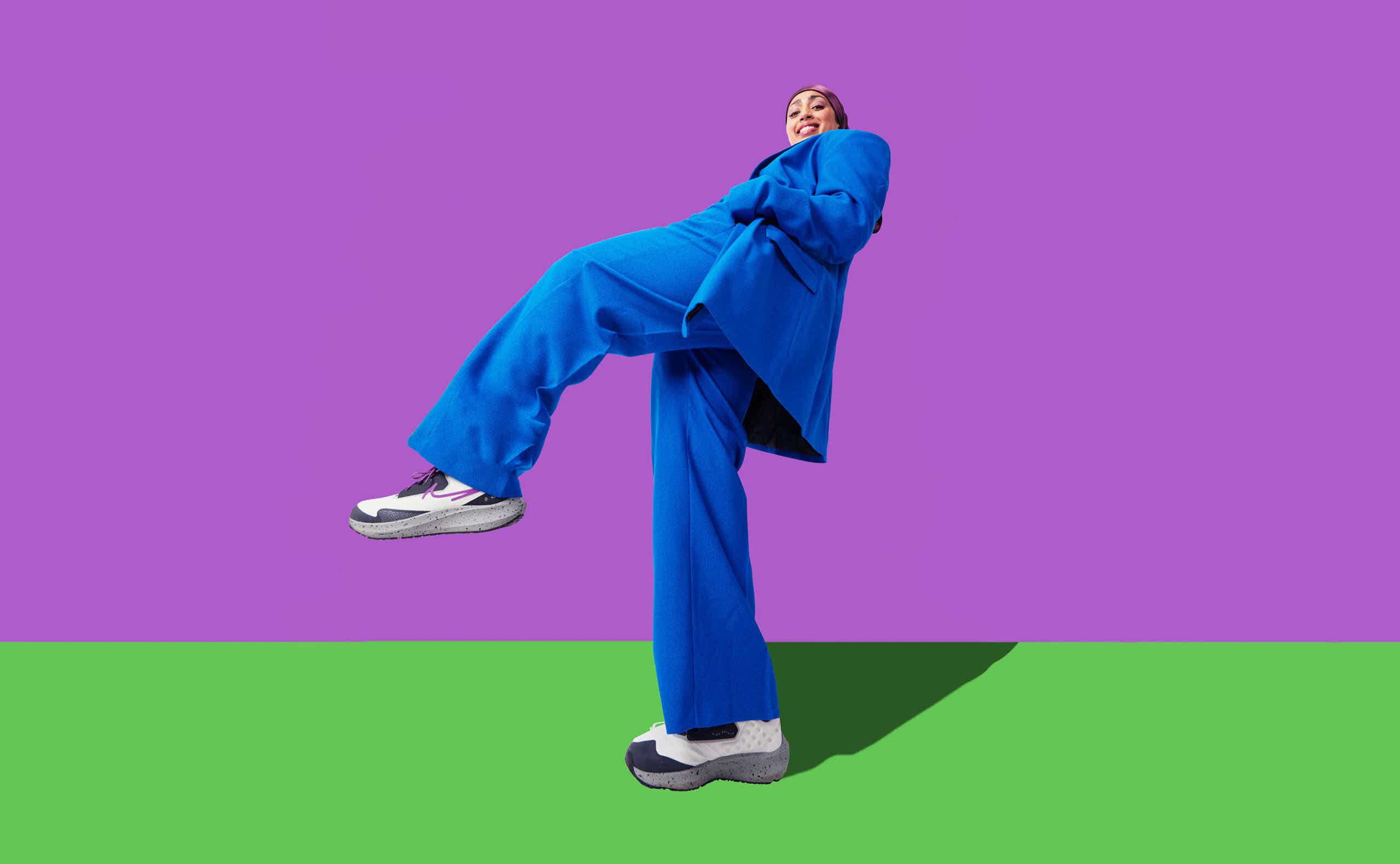 A woman in a blue suit steps high