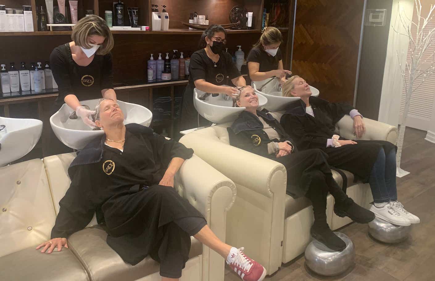 katie couric having her hair washed at a salon with two friends