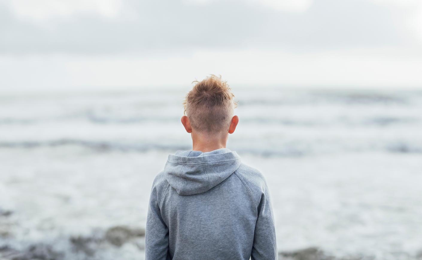 boy facing the ocean