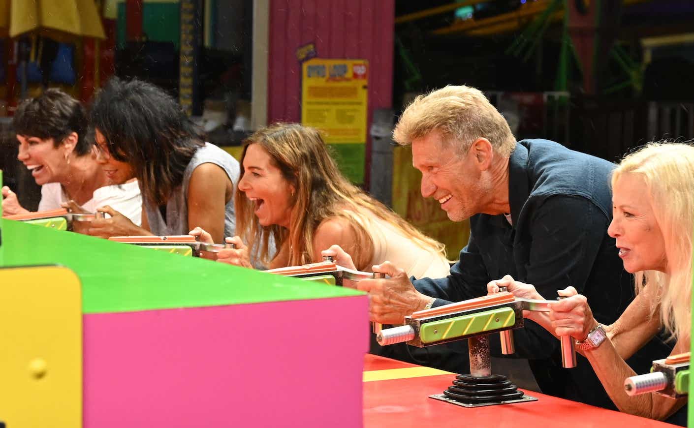 the cast of the golden bachelor playing carnival games