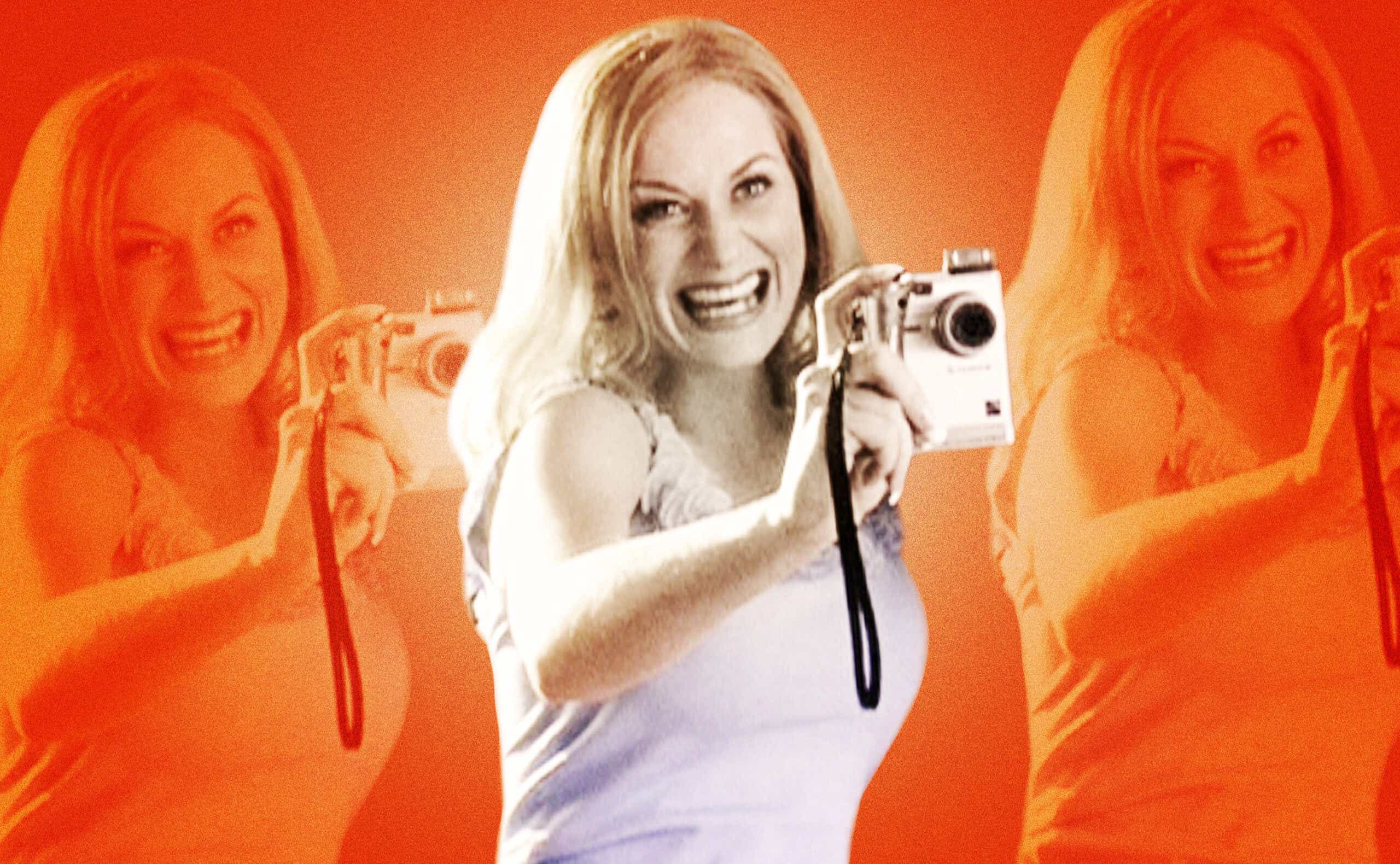 Amy Poehler holding up video camera and smiling in Mean Girls