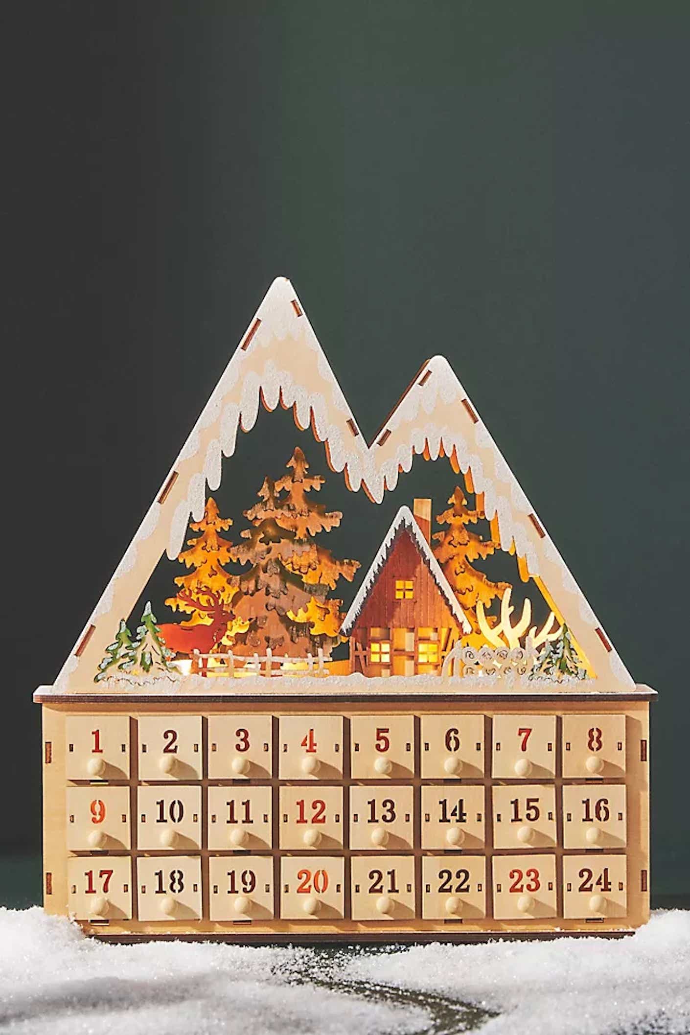 A wooden advent calendar shaped like a house