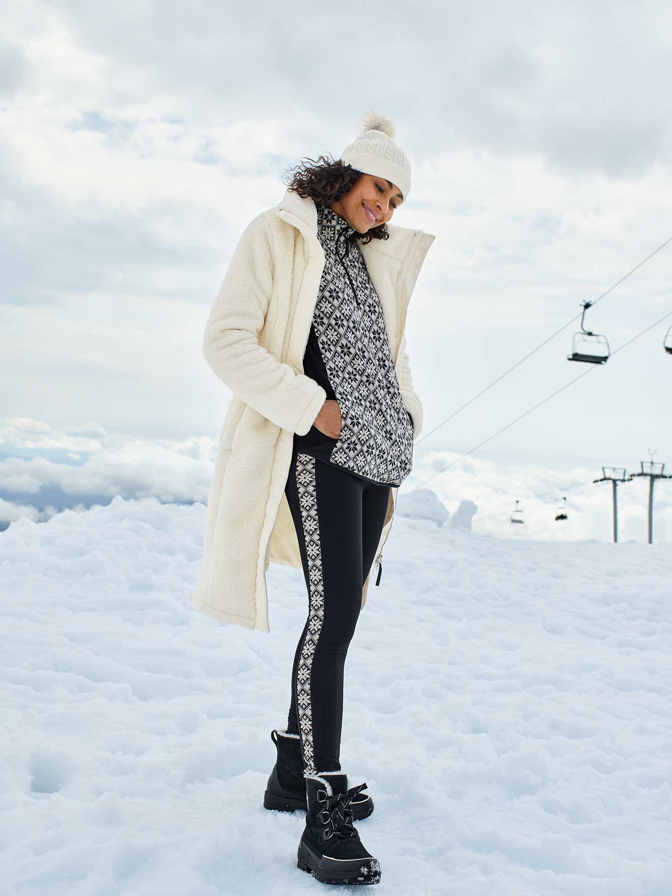 Woman in warm outfit standing in the snow