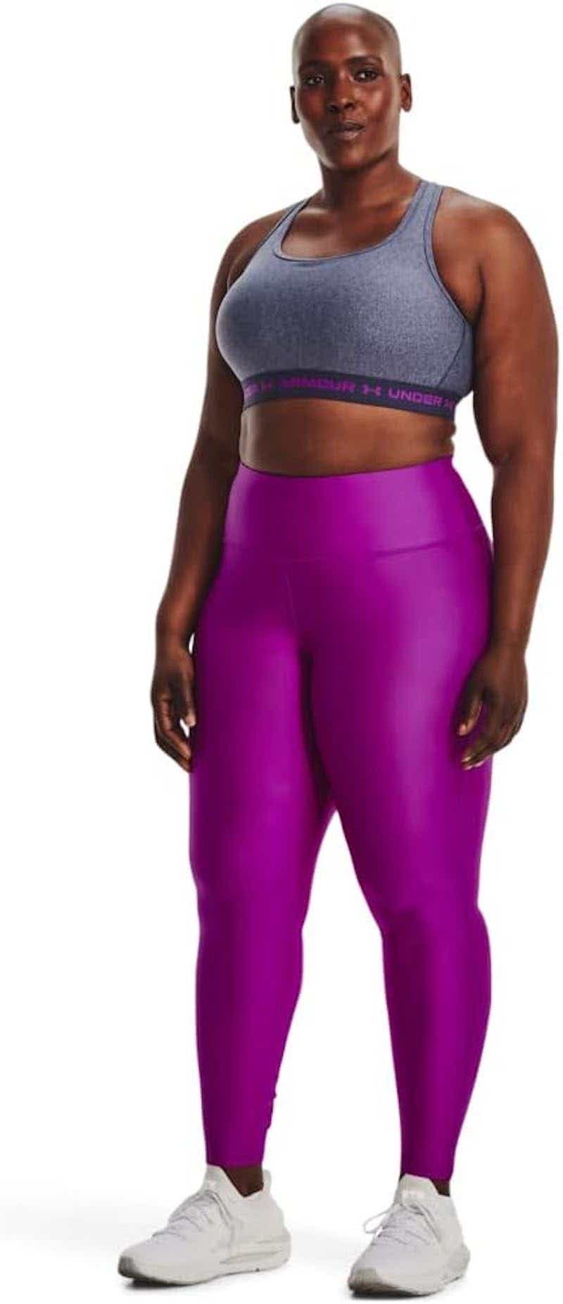 woman wearing sports bra and purple leggings