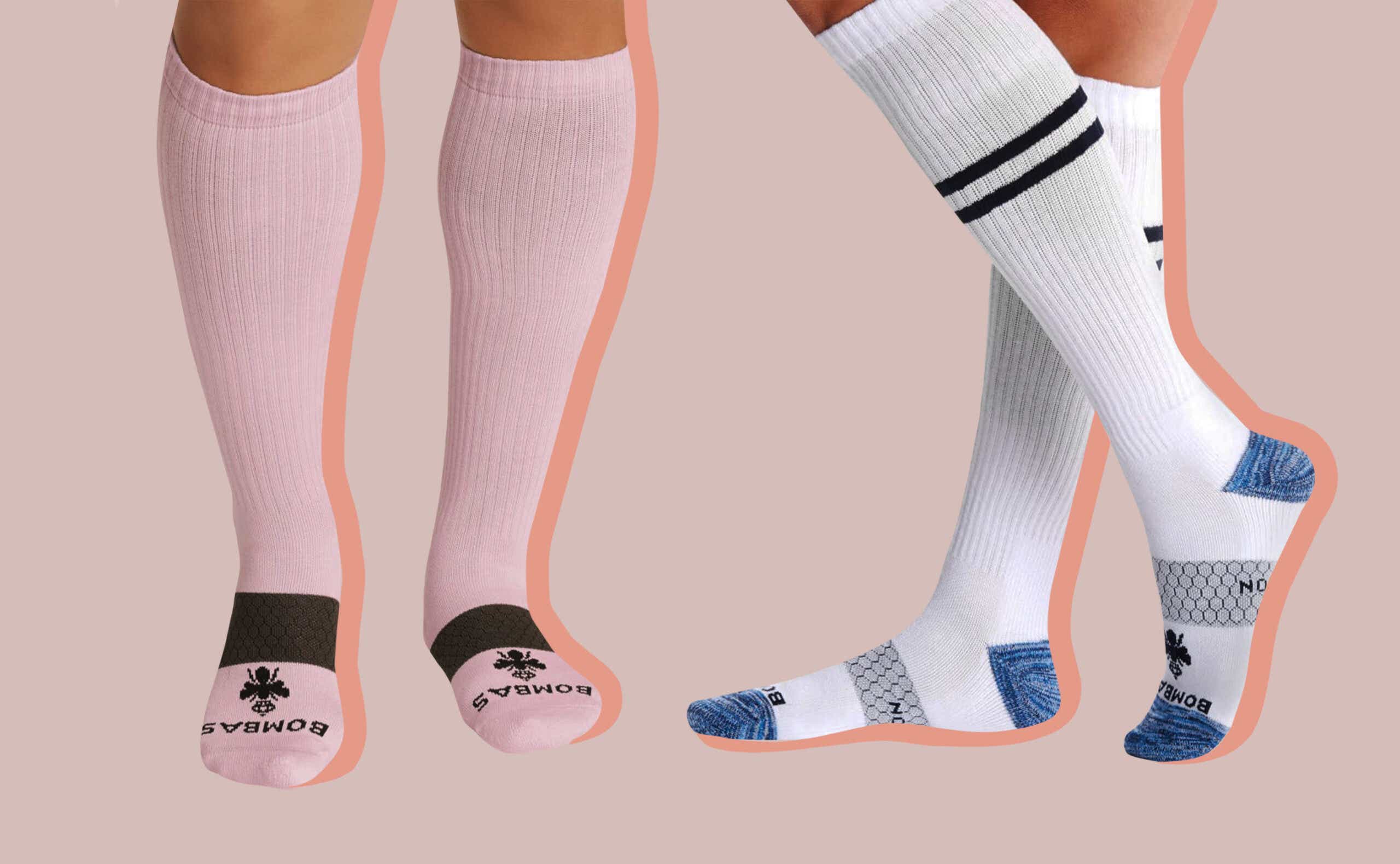 Two sets of legs wearing Bombas Compression socks on a pink background