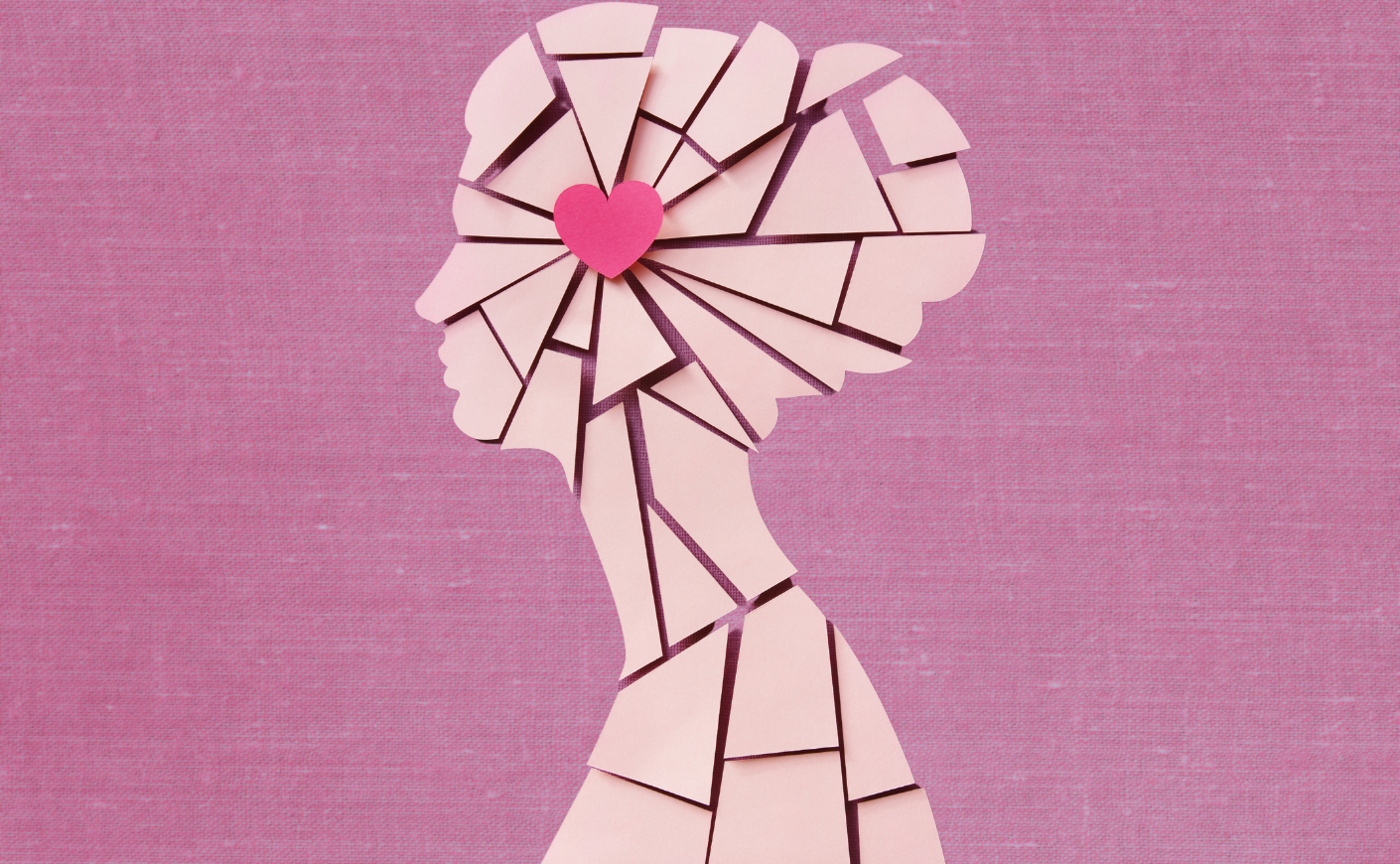 cracked silhouette of a women with a heart at the center