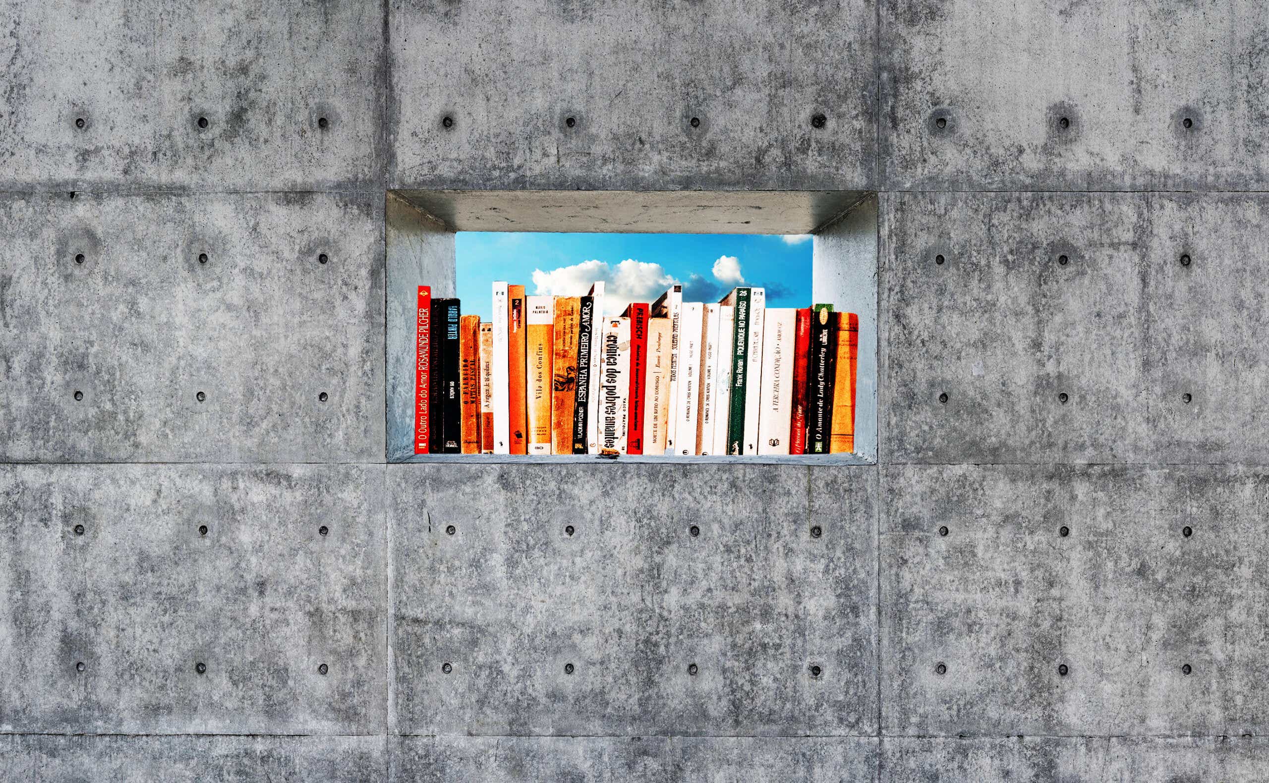 stack of books in the window of a concrete wall