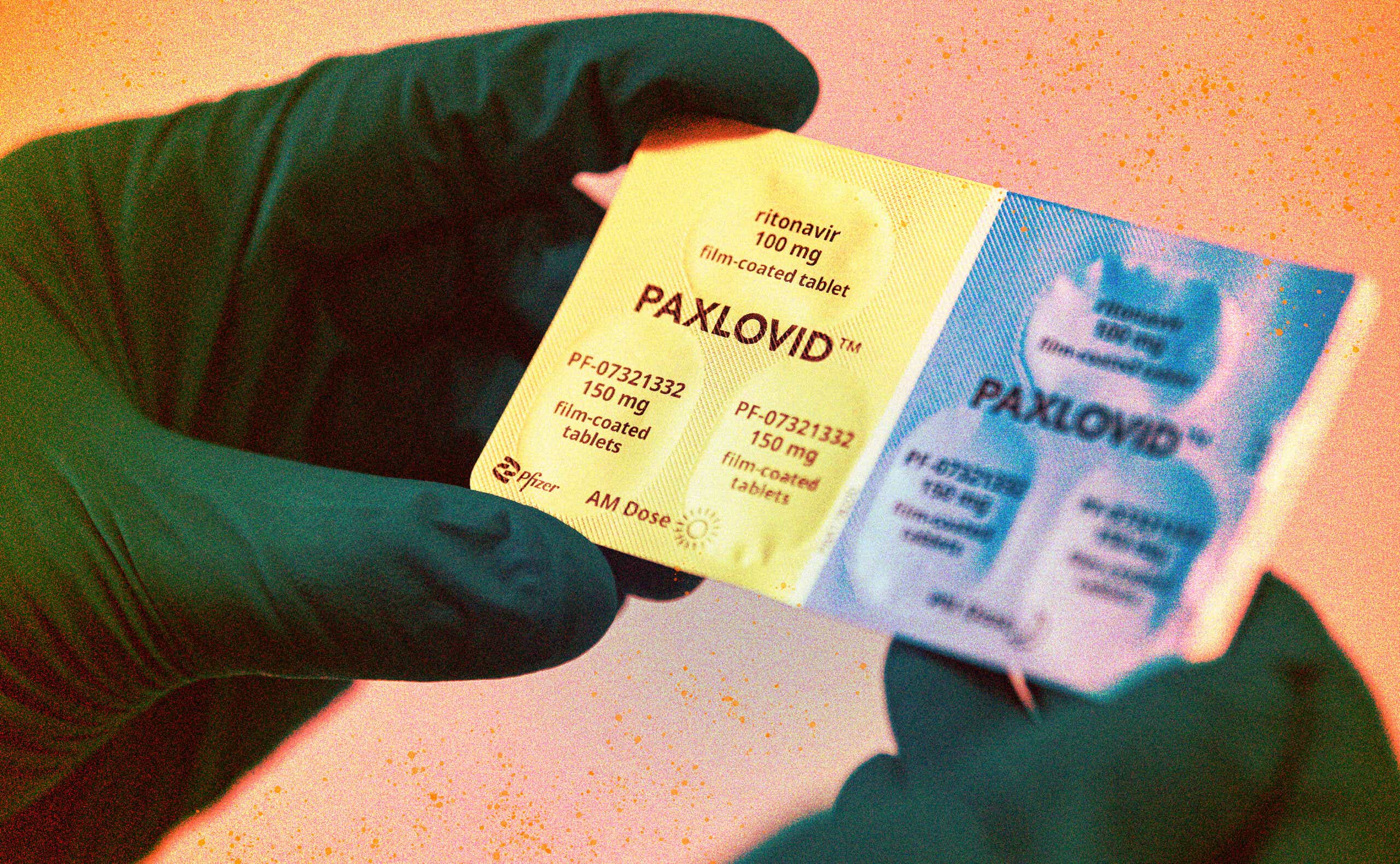 person wearing gloves holding paxlovid pills