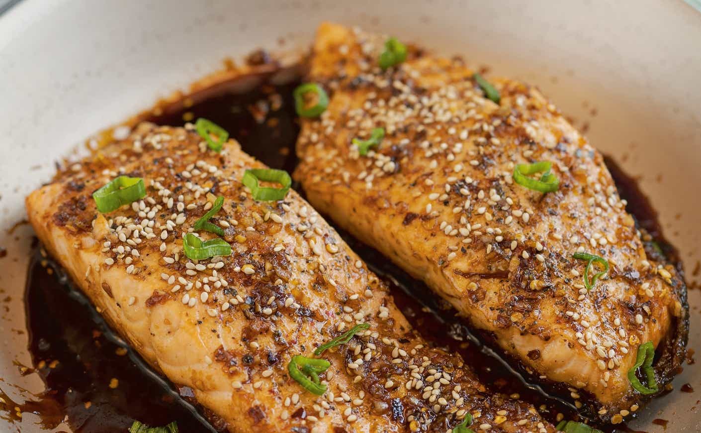 A dish of two miso glazed salmon fillets.