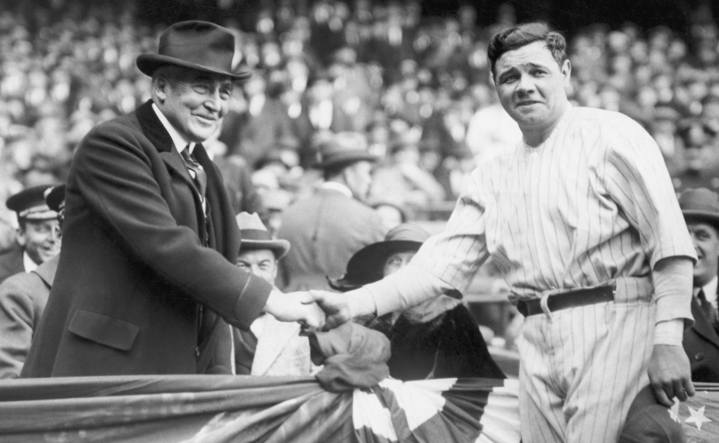 President Warren G. Harding shakes hands with New York Yankee player Babe Ruth during an April 4, 1923 visit to Yankee Stadium.