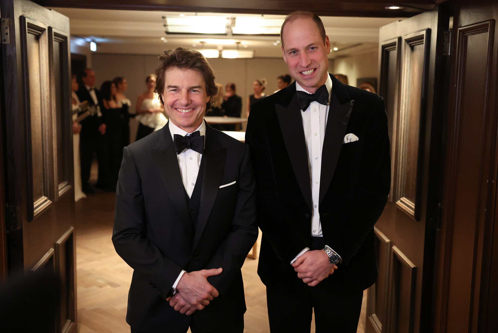 Tom Cruise and Prince William wear tuxes and pose for a photo.