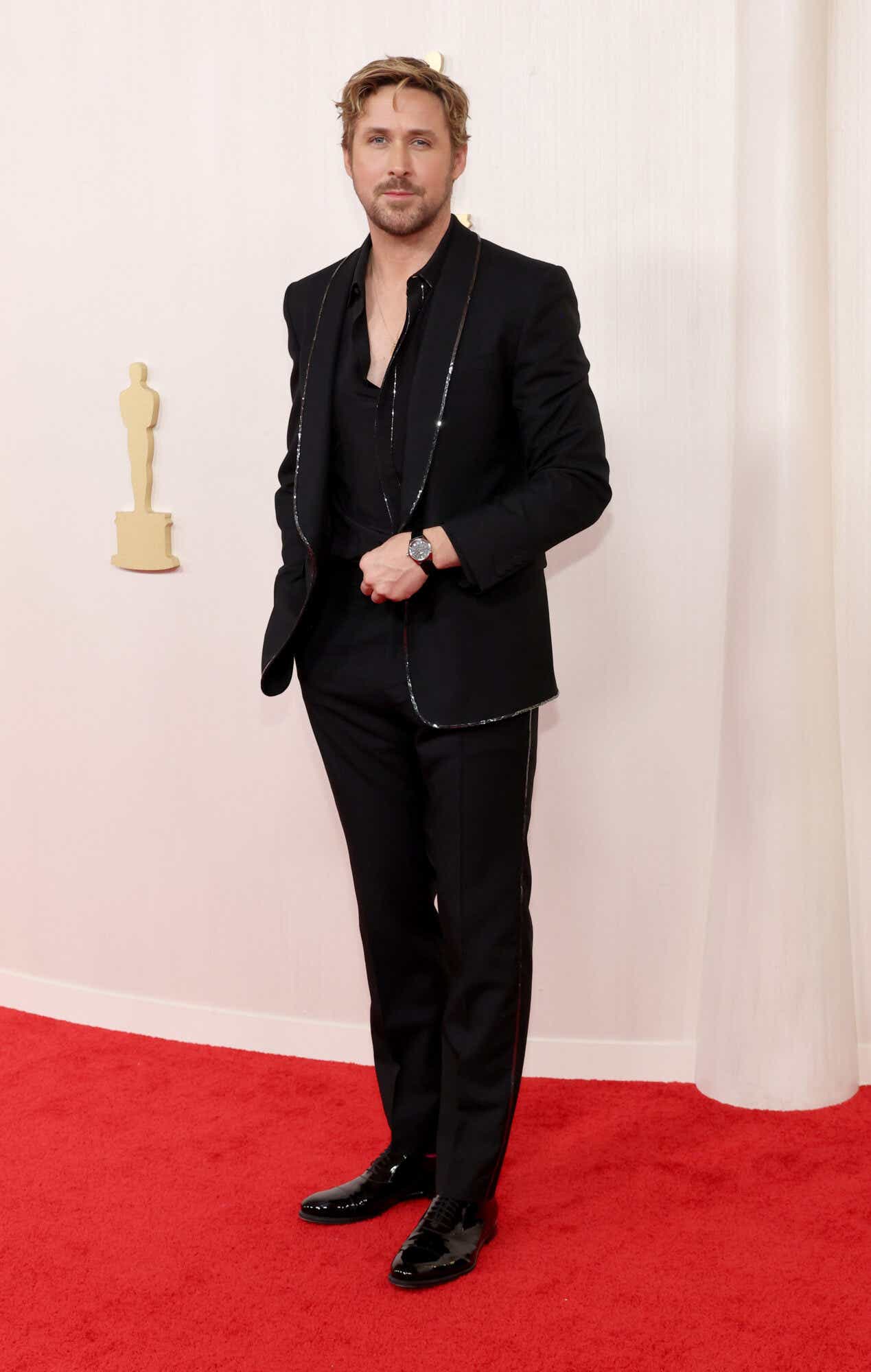 Ryan Gosling wears a black suit with a sequined trim to the Oscars.