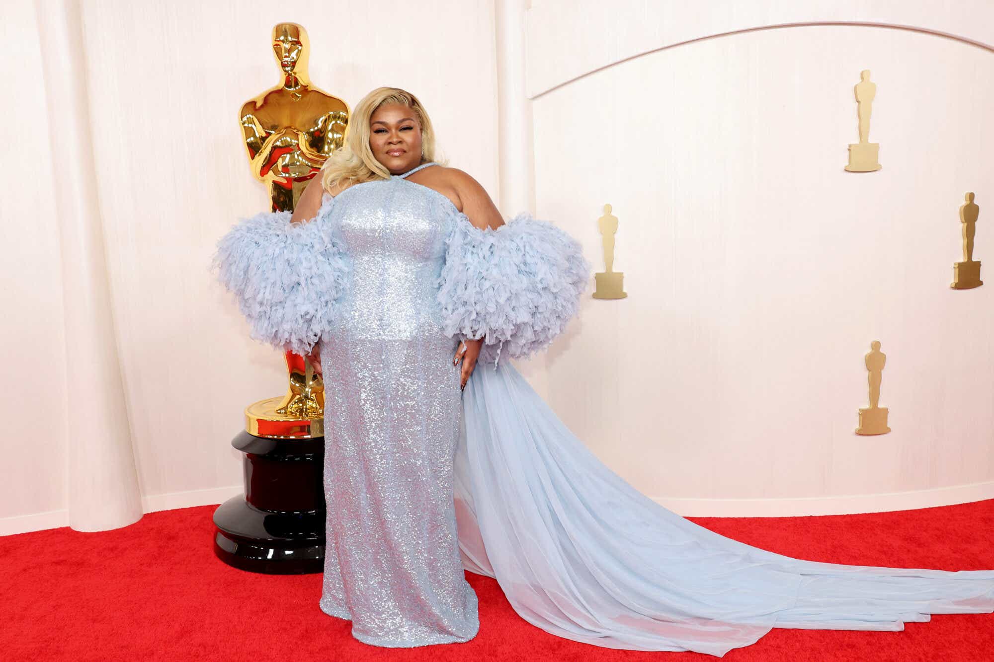 Da'Vine Joy Randolph wears a light blue sequined gown with ruffled sleeves and a long train to the Oscars.