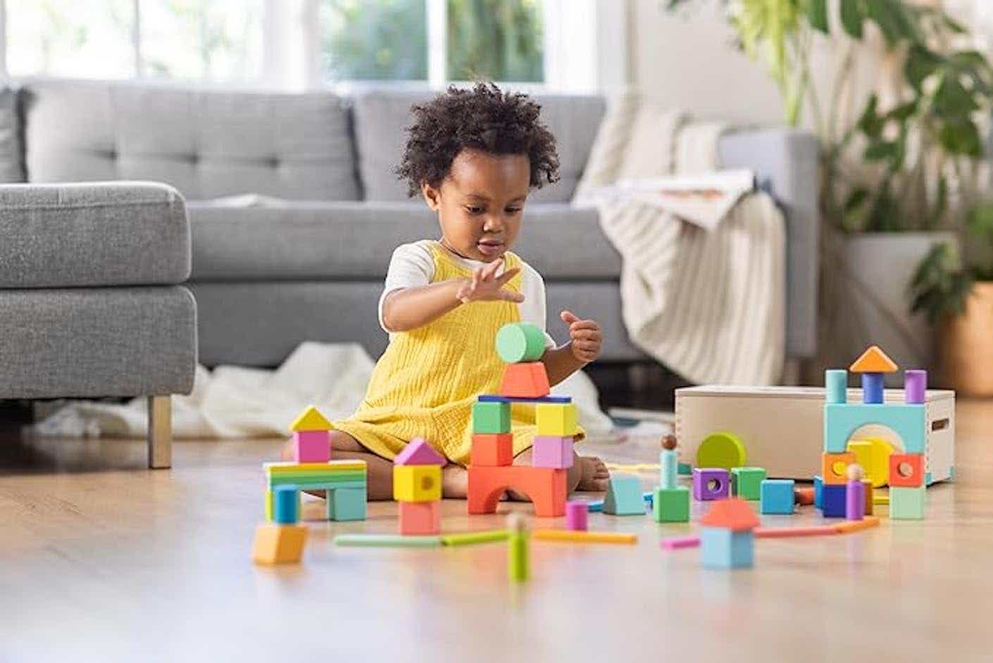 A toddler playing with blocks.